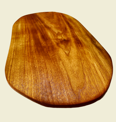 Smooth wooden serving board with a natural finish and an organic shape.